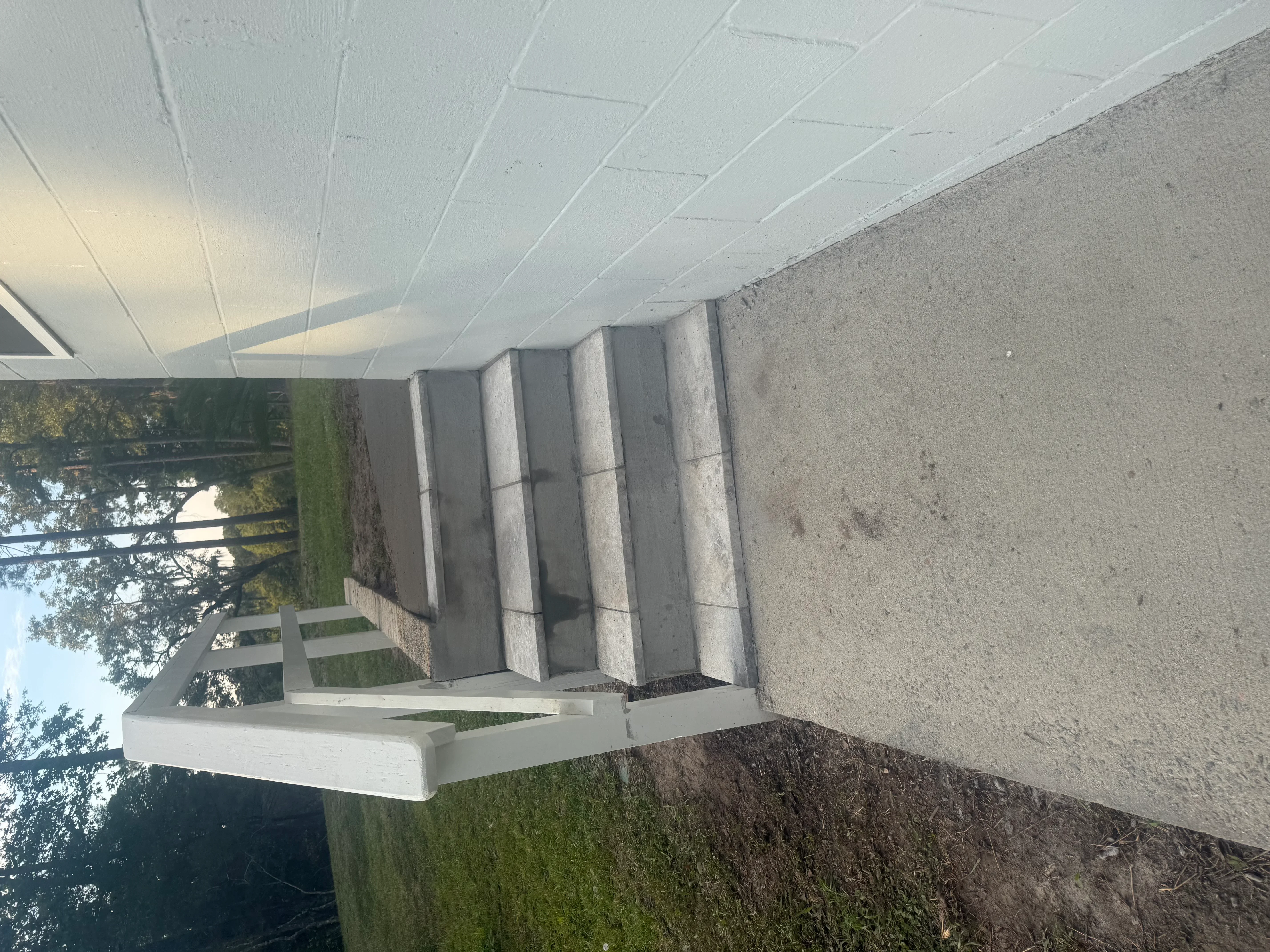 Concrete foundation with white vinyl soffit and fascia trim installation