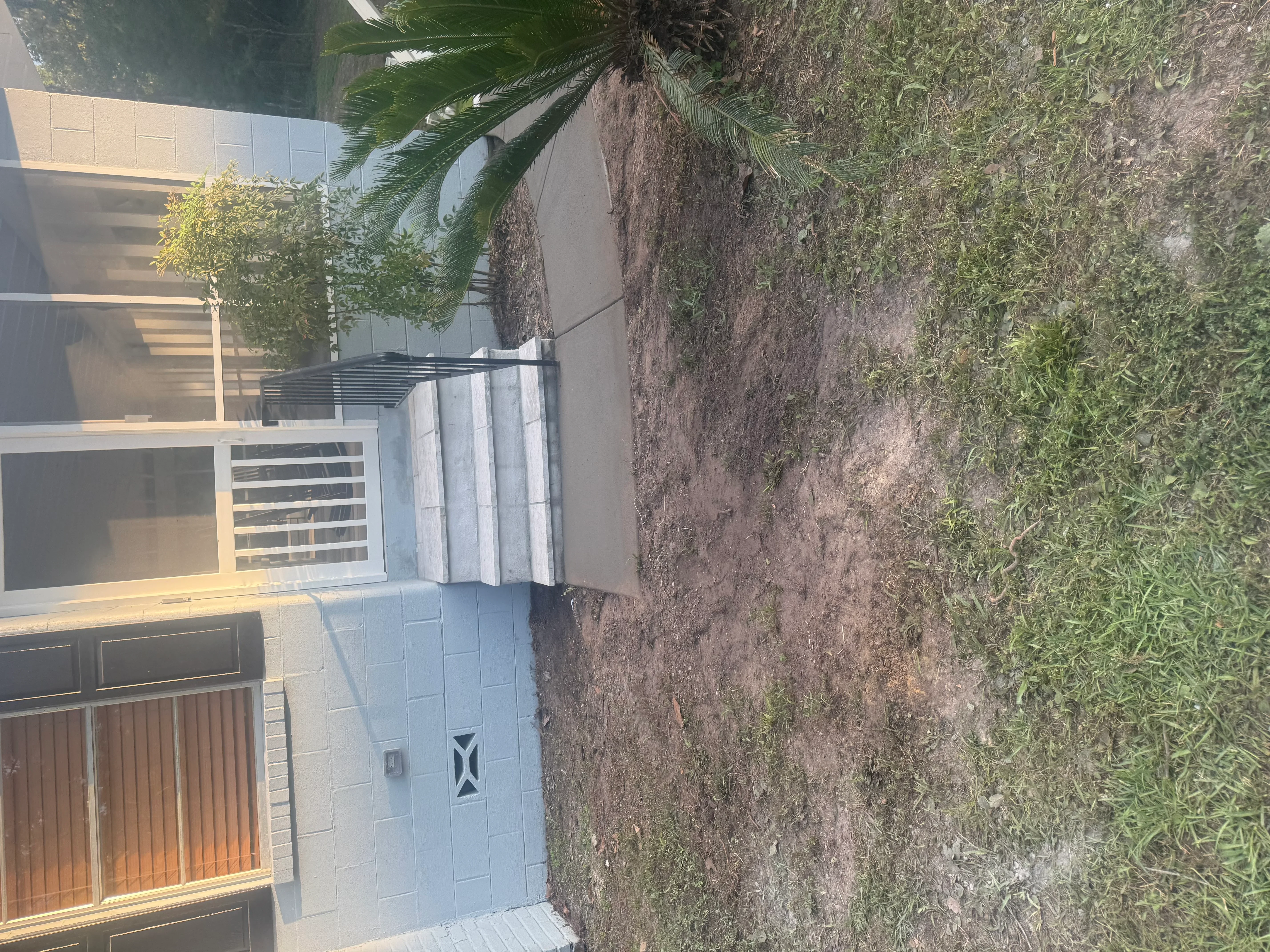 Light-colored concrete driveway and entry apron with garage integration